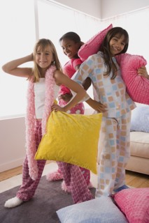 Portrait of three girls (10-11) playing at slumber party. Photo : Rob Lewine