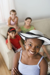 Portrait of girl (10-11) wearing hat with veil at slumber party. Photo : Rob Lewine