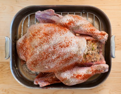 Raw turkey on roasting pan.