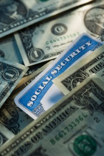 Studio shot of social security card and banknotes.