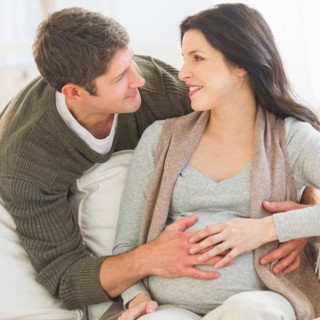 Man touching pregnant woman's belly.