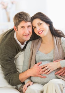 Man touching pregnant woman's belly.
