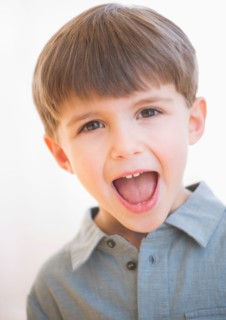Studio portrait of boy (4-5) yelling.