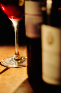 Studio shot of wine glass and bottles.