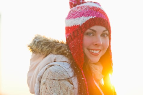 Portrait of young woman wearing knit hat.