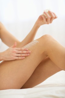 Studio shot of young woman caring for skin.