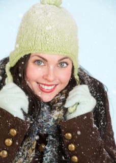 Studio portrait of woman in winter clothing.