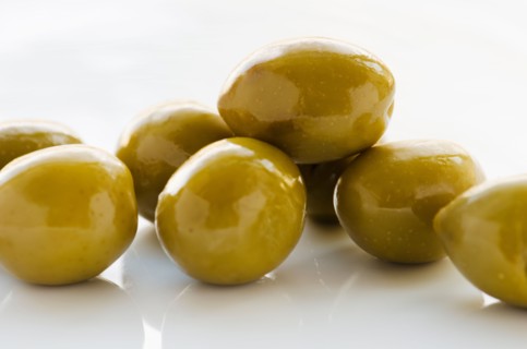 Close-up of green olives, studio shot.