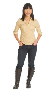 Mid adult smiling woman standing, studio shot.