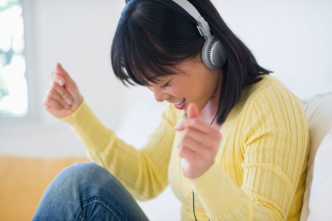 Smiling woman listening music.