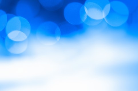Glowing light on blue background, studio shot.