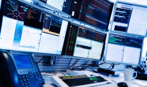 Monitors above trading desk.