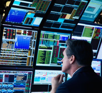 Stock trader working on computer.