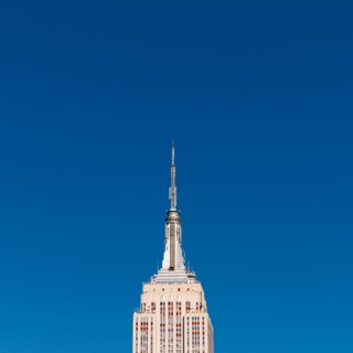 USA, New York, New York City, Empire State Building against blue sky.