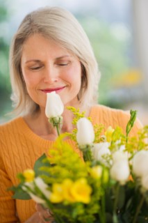 Portrait of senior woman with bouquet celebrating Mother's Day.