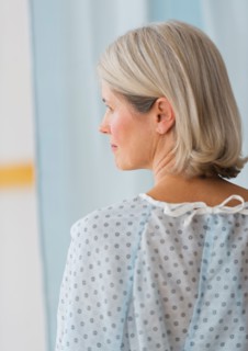 Rear view of senior female patient in hospital.