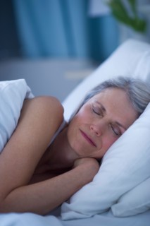 Senior woman sleeping in bed .