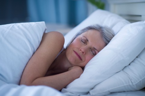 Senior woman sleeping in bed .