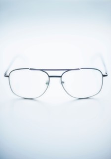 Close up of glasses on blue background, studio shot.