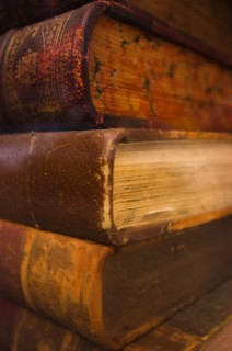 Close up of antique books in leather covers, studio shot.