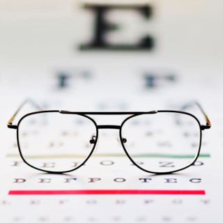 Close up of glasses on eye chart, studio shot.