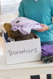 Man packing clothes for donation.
