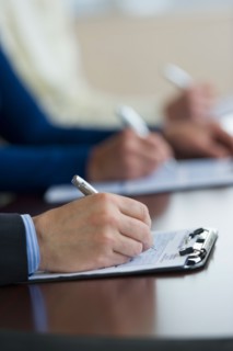 Close up of man's hands filling application form.