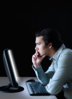 Man working with computer, studio shot.