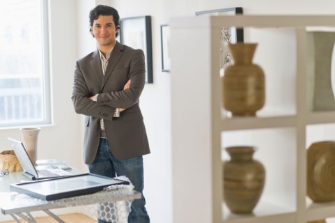 Portrait of man in his art gallery.