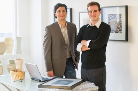 Two men working in art gallery.