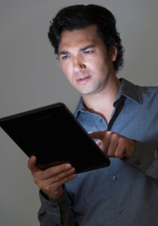 Studio shot of businessman using digital tablet.