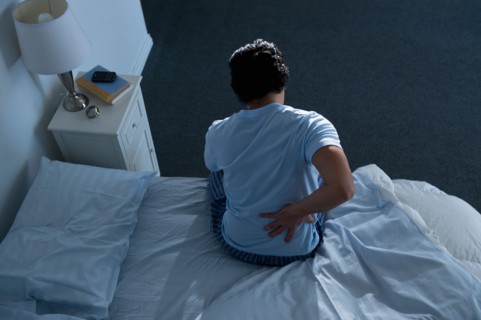 Man sitting on bed .