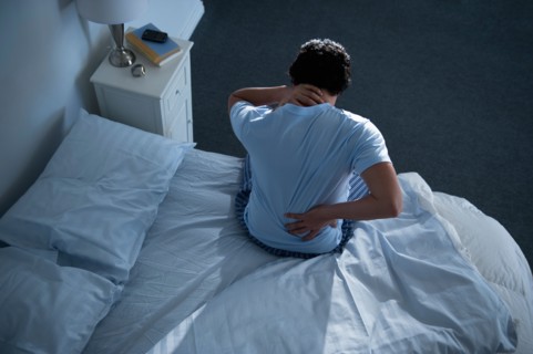 Man sitting on bed .