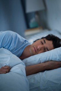 Man sleeping in bed.