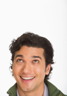 Studio shot of young man looking up.