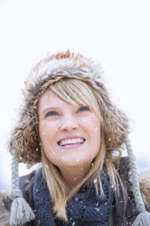 Portrait of woman wearing knit hat smiling.
