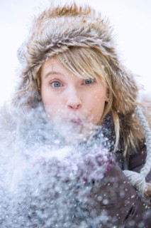 Woman blowing snow.