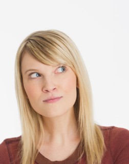Studio portrait of pensive woman.