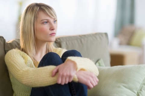 Woman sitting on sofa.