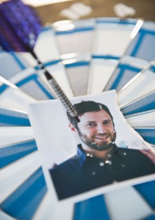 Photograph of man stuck with darts. Photo : Jamie Grill