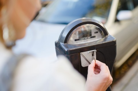 USA, New York State, New York City, Brooklyn, Woman inserting coin into parking meter. Photo :
