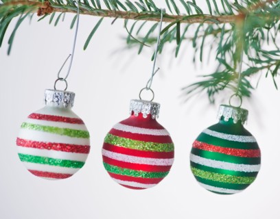 Studio shot of striped Christmas ornaments hanging on Christmas tree. Photo : Daniel Grill