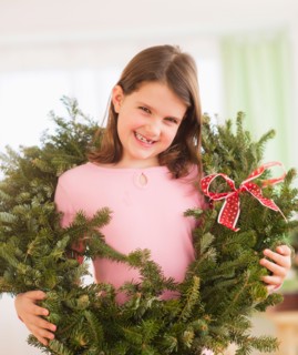 Portrait of girl (8-9) with christmas wreath. Photo : Daniel Grill