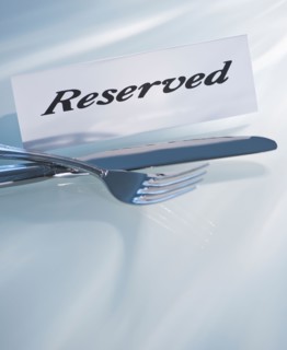Studio shot of silverware and Reserved sign. Photo : Daniel Grill
