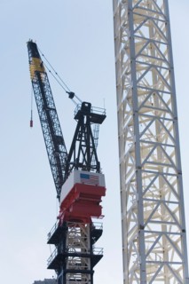 Crane at construction site. Photo : fotog