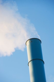 Low angle view of smoke stack. Photo : fotog
