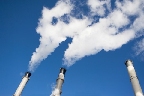 Low angle view of factory chimneys. Photo : fotog