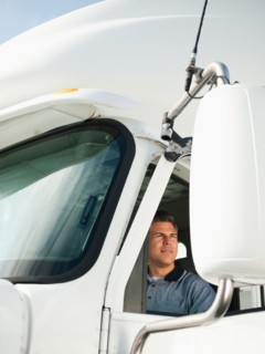 Truck driver sitting in truck.