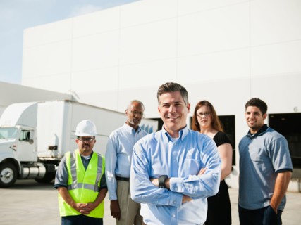 Portrait of warehouse workers and manager.