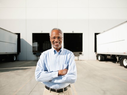 Portrait of businessman outside warehouse.